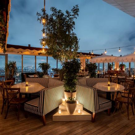 The outdoor dining area of Harriet's Rooftop at night