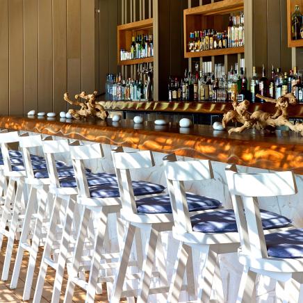 white and blue chairs along the Sandbox Bar of 1Hotel South Beach